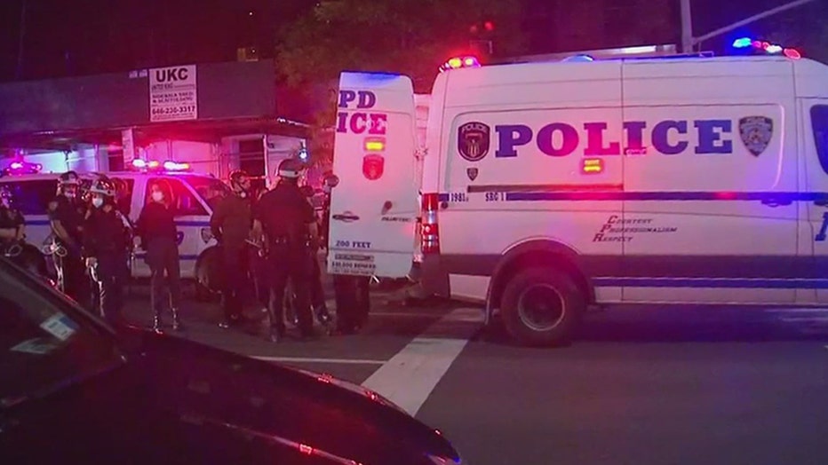 NYPD officers and an NYPD van