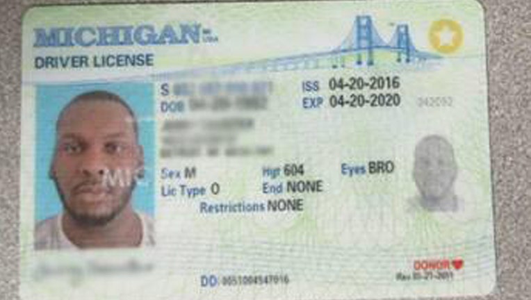 Fake Michigan ID showing a photo and bio data blurred out