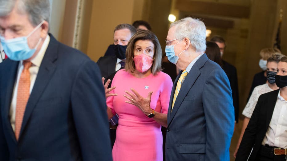 FILE - Speaker of the House Nancy Pelosi, D-Calif., and Senate Majority Leader Mitch McConnell, R-Ky., arrive for the Joint Congressional Inaugural Ceremonies Committee meeting. 