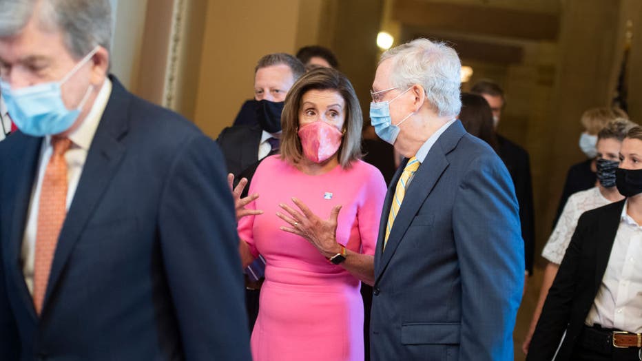 FILE - Speaker of the House Nancy Pelosi, D-Calif., and Senate Majority Leader Mitch McConnell, R-Ky., arrive for the Joint Congressional Inaugural Ceremonies Committee meeting.