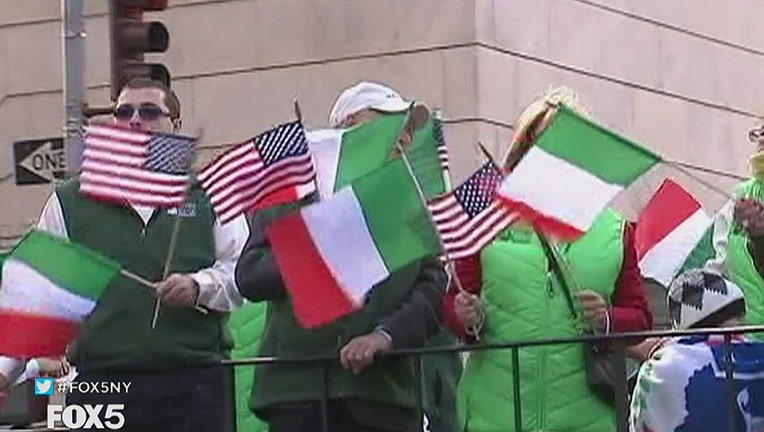 Parade participants waving U.S. and Italian flags