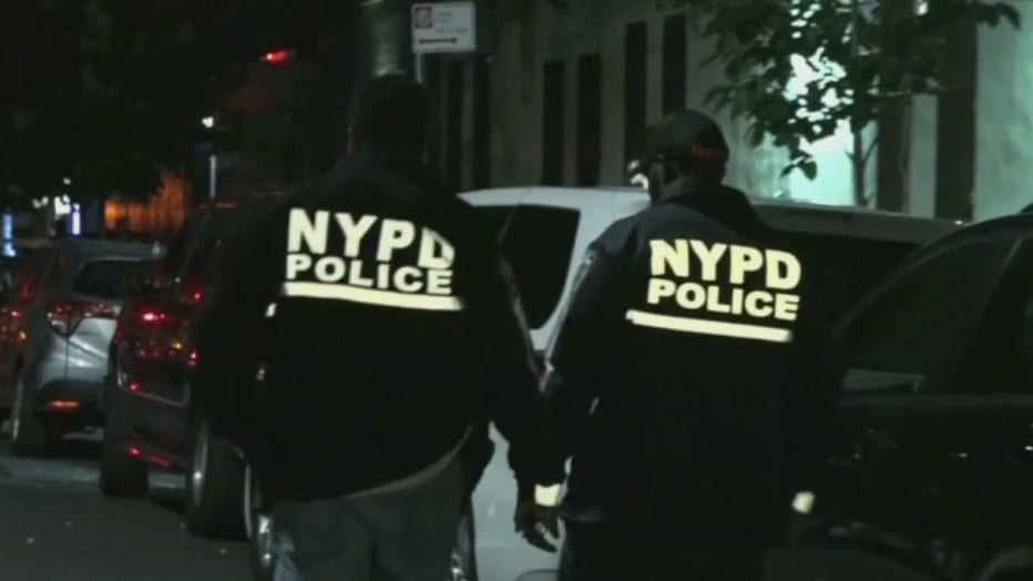 Police officers wearing jackets with the lettering NYPD Police