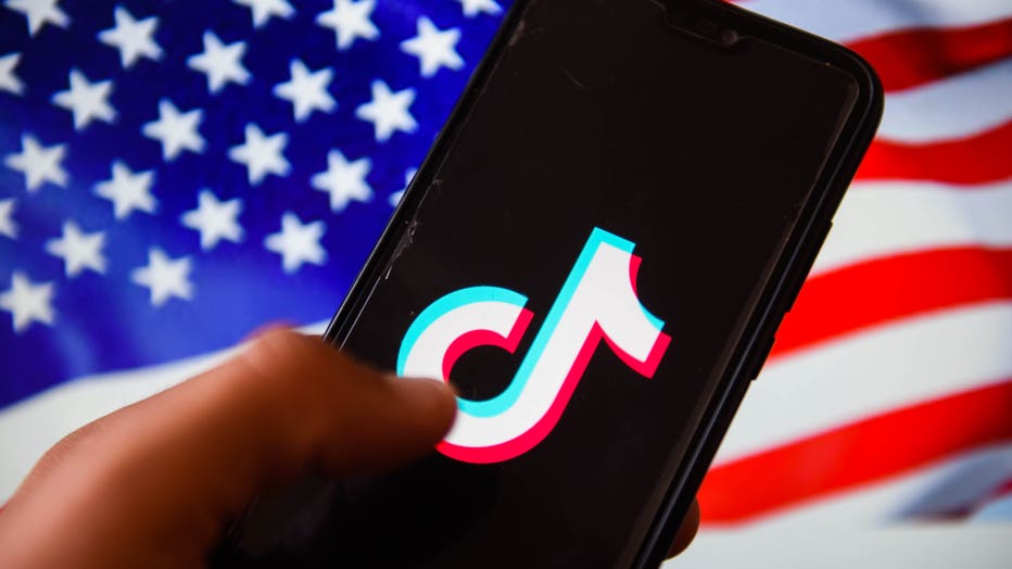 In this photo illustration, a TikTok logo is displayed on a
