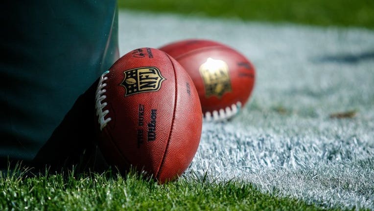 Footballs lay against the goal-post prior to the NFL game.