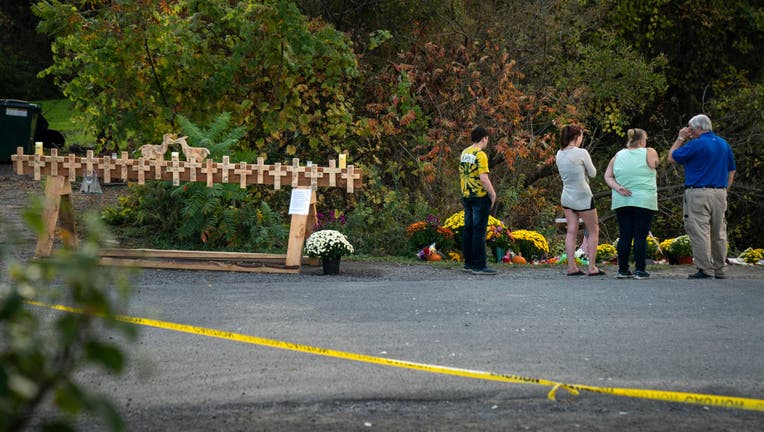 Mourners visit the site of a fatal limousine crash that killed 20 people near the intersection of Route 30 South and Route 30A, October 10, 2018 in Schoharie, New York.