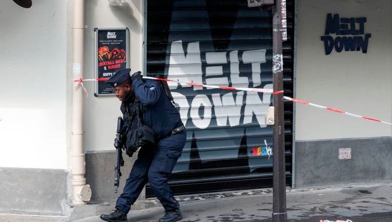 A French police officer secures the area after several people were injured near the former offices of the French satirical magazine Charlie Hebdo following an attack by a man wielding a knife in the capital Paris on September 25, 2020.