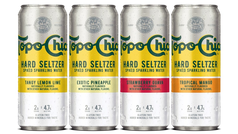 4 cans of hard seltzer; the cans are silver with yellow, orange and red variations