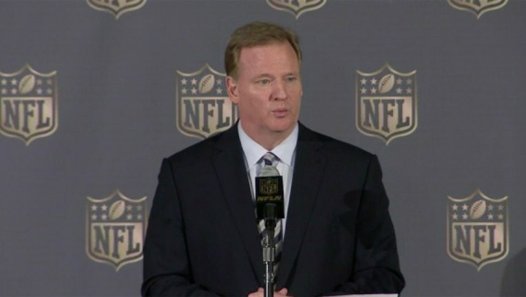 Roger Goodell speaks into a microphone