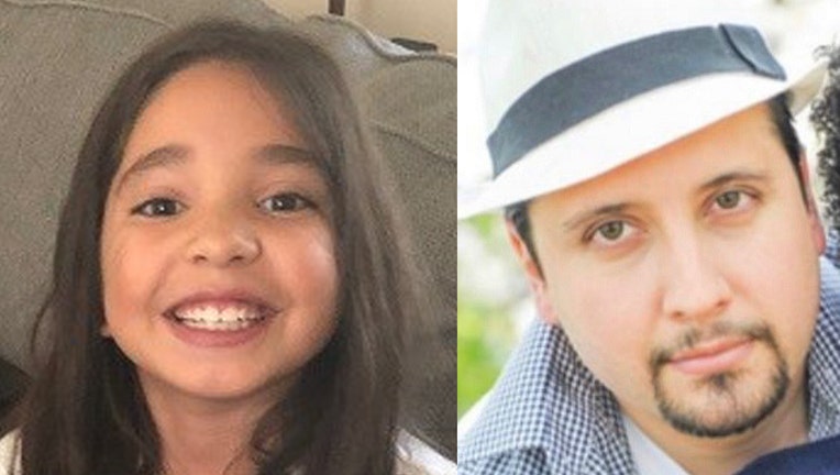 Smiling girl with brown hair and brown eyes and man with a white hair and goatee