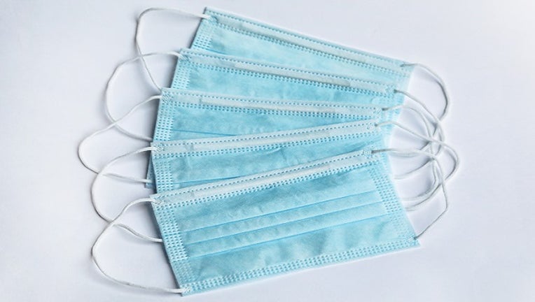 FILE - Surgical masks on a white surface stock photo.