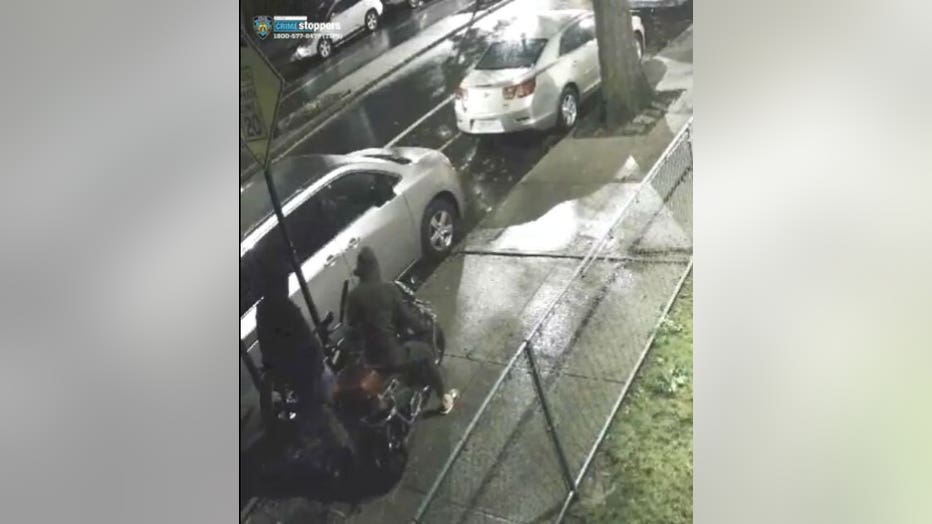 Police were looking to speak with two persons of interest seen in video during the time of the shooting attempting to steal a bicycle that was locked in front of the building. (