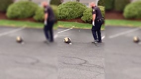 Police officer helps skunk with head stuck in container