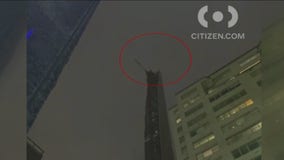 Debris falls from spinning crane atop 'skinniest' building in world