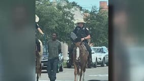 Black man sues Texas city for $1M after viral photo showed mounted officers leading him by rope