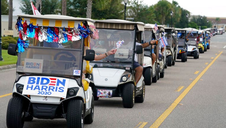 A parade of golf carts supporting Joe Biden.