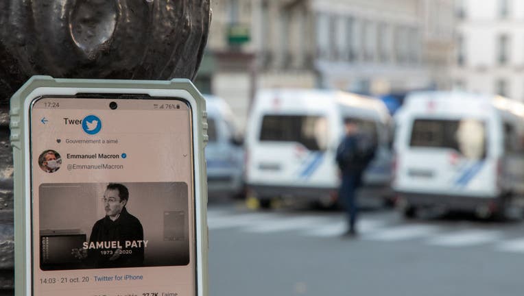 A close-up at French President Emmanuel Macron's official twitter account showing a picture of Samuel Paty as police are deployed around Sorbonne University during a national tribute to the slain teacher on October 21, 2020 in Paris, France.