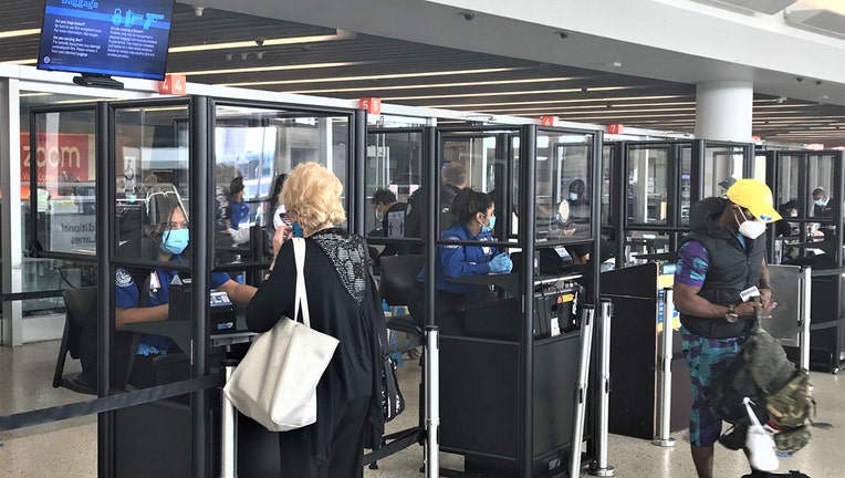 Clear acrylic barriers around several TSA checkpoints