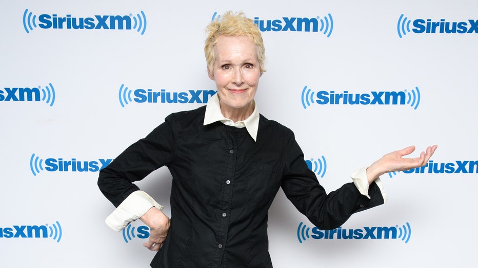 E. Jean Carroll stands in front of a Sirius XM logo wall
