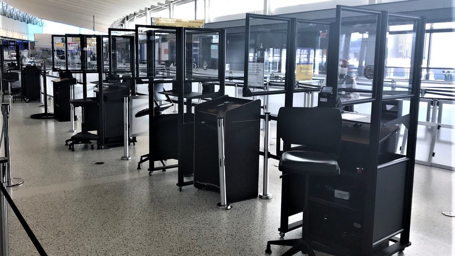 Clear acrylic barriers around several TSA checkpoints