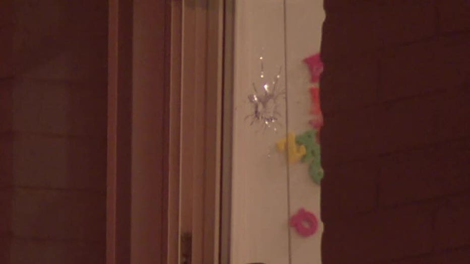 Bullet holes are seen in the window of a Trenton home where two children were killed.