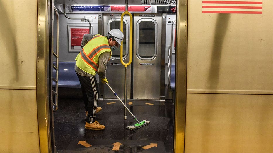 A cleaning crew disinfects a New York City subway train on May 4, 2020 in New York City. (Photo by Stephanie Keith/Getty Images)