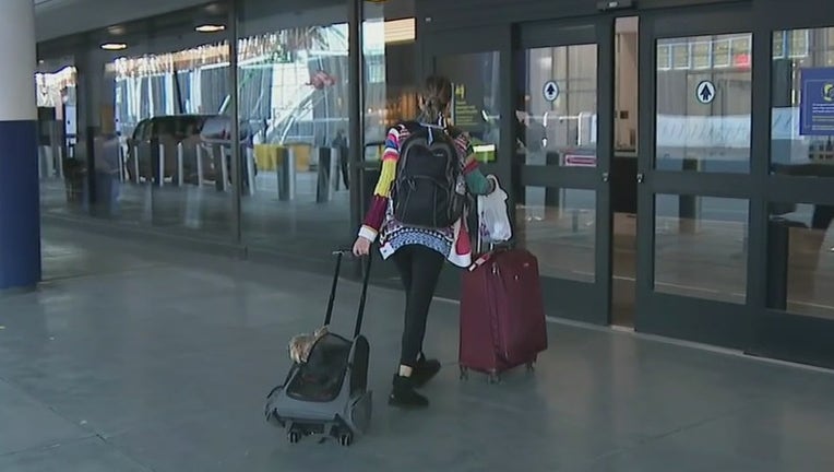 A traveler enters a terminal at LaGuardia Airport