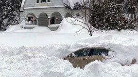 Man rescued after 10 hours in car buried by snow plow