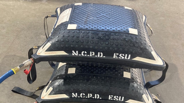 Police use inflatable devices to unpin man