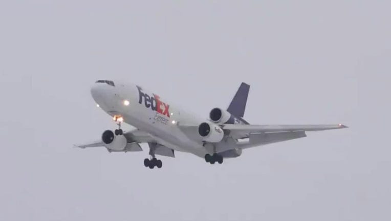 A FedEx jet approaches a runway