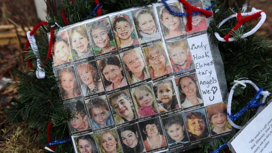 Photos of Sandy Hook Elementary School massacre victims sits at a small memorial near the school on January 14, 2013 in Newtown, Connecticut.