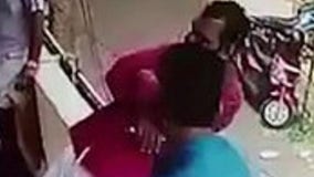 Video shows bystander grabbing man’s foot after he falls backward off of balcony