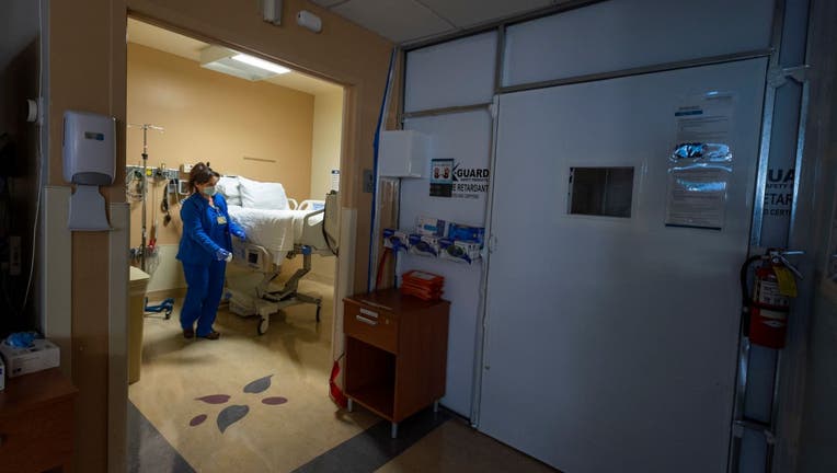 Cathy Cullen, RN cleans a temporary COVID-19 patient 