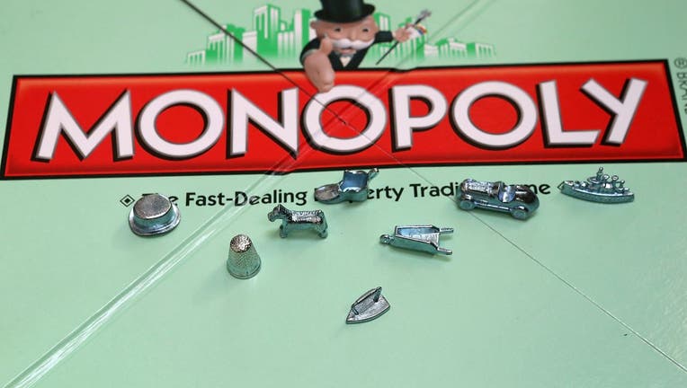 In this photo illustration, Monopoly game pieces are displayed