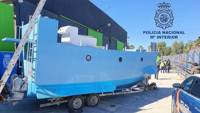 In this handout photo from the Spanish National police, a homemade semi submersible submarine sits outside a warehouse in Malaga, Spain. (Police Nacional)