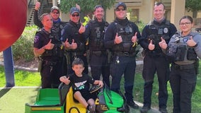 Tempe police officers surprise boy with new toy gator tractor after his old one was stolen