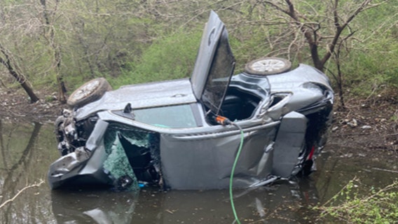 Man rescued from car overturned in water