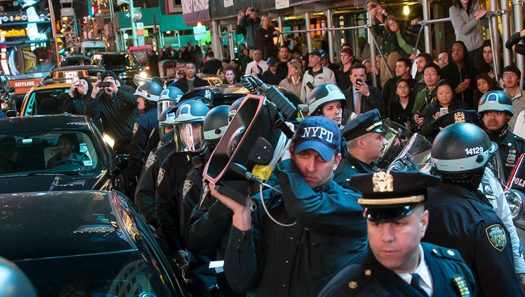 Cop holding a sound cannon amid a protest