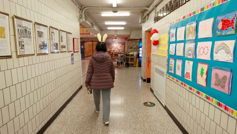 Principal Alice Hom walks through a hallway