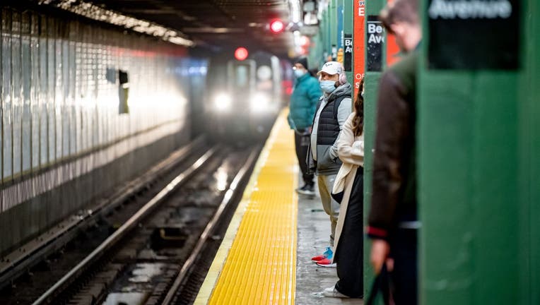 Commuters wait for the subway
