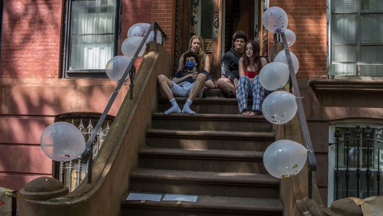 BROOKLYN, NY - MAY 17: A social distancing birthday party is held on the front stoop for two twin teenagers turning eighteen on May 17, 2020 in Brooklyn, New York.
