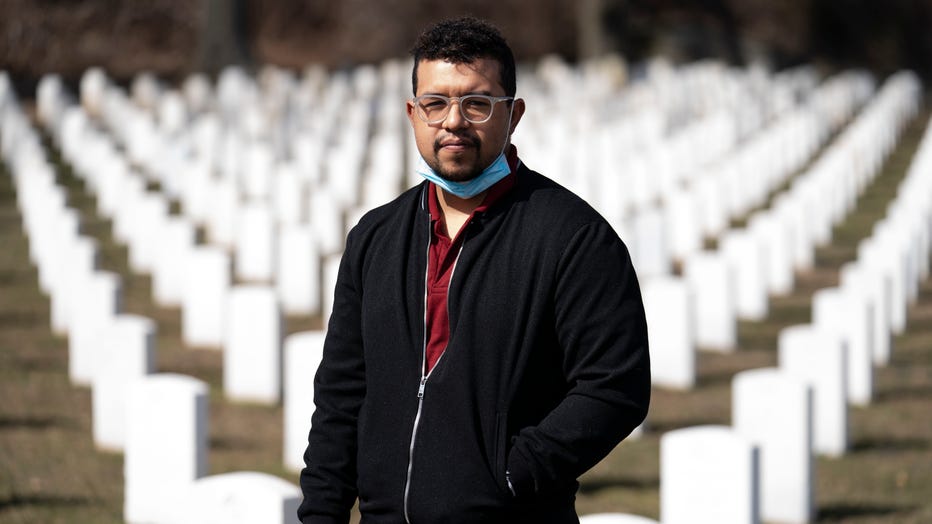 Undertaker Jesus Pujols stands for a portrait at Cypress Hills National Cemetery, Friday, March 12, 2021, in the Brooklyn borough of New York.