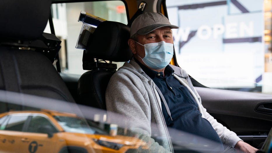 Nicolae Hent sits for a portrait in his taxi outside a midtown Manhattan hotel, in New York on March 19, 2021. 