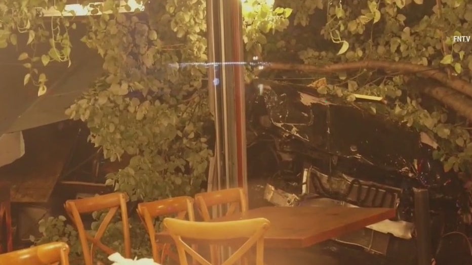 A female pedestrian was struck by debris and injured when a driver plowed into an outdoor dining structure in Astoria.