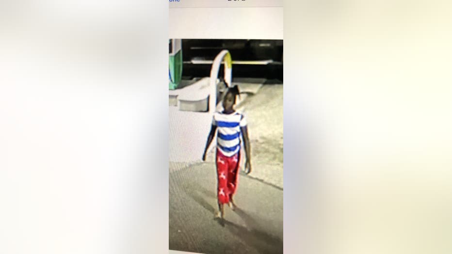 Surveillance video of the black girl with a thin build shows her wearing pink pajama pants, a white and blue horizontal striped shirt, large hoop earrings, and no shoes.
