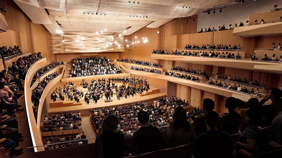Artist's rendering of interior of a concert hall depicting people sitting in seats watching an orchestra on a stage