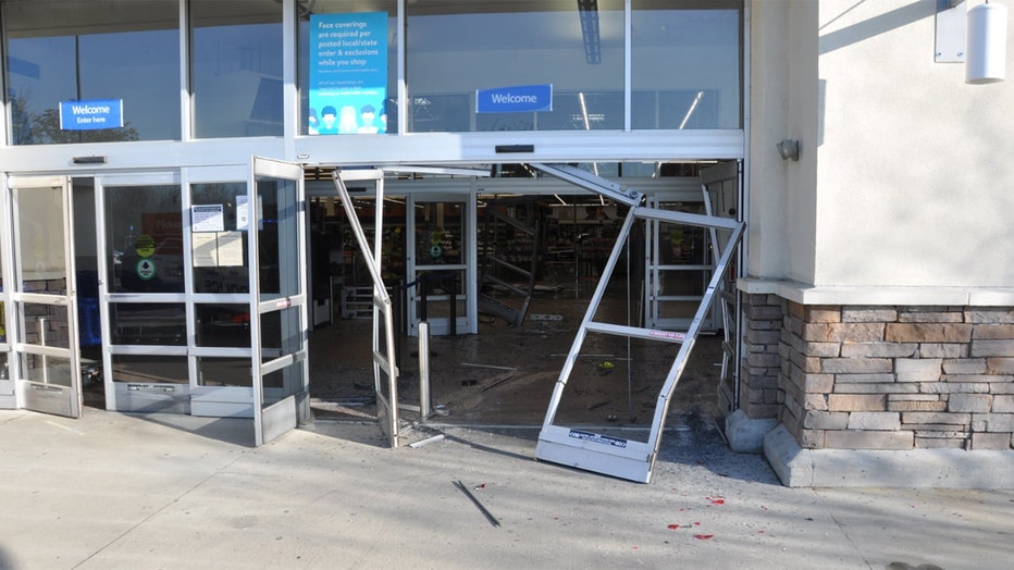The police department released a photo showing the smashed front door of the Walmart.(Concord Police Dept.)