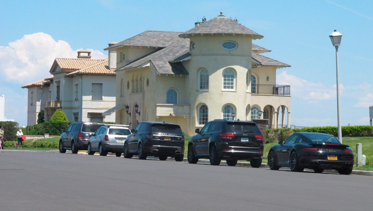 Cars are parked on an oceanfront street in Deal, N.J., on May 15, 2021s
