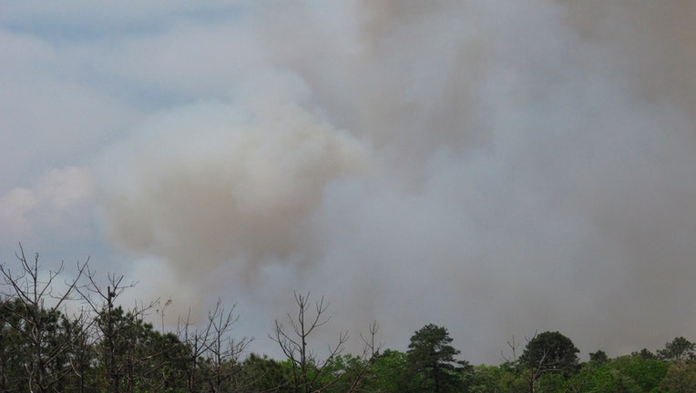 Smoke rises from a forest fire in Little Egg Harbor, N.J., on Monday, May 17, 2021.