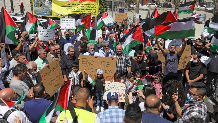 Palestinians demonstrate in the city of Ramallah, in the occupied West Bank, in solidarity with Gaza on May 18, 2021. (Photo by ABBAS MOMANI/AFP via Getty Images)