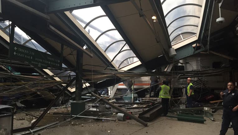 A NJ Transit train seen through the wreckage.